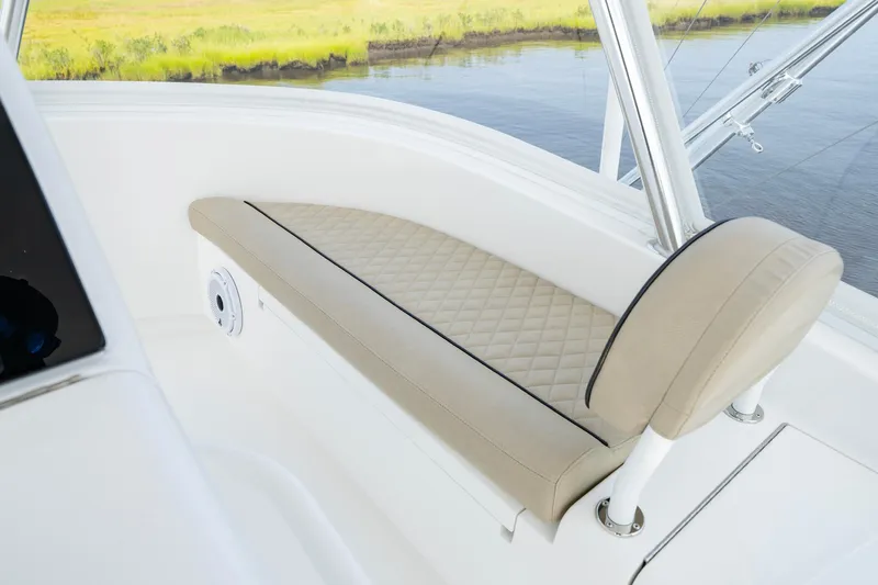 Slide: The Image of 2022 Viking 46 Billfish boat interior with cushioned seating and water view. - 40