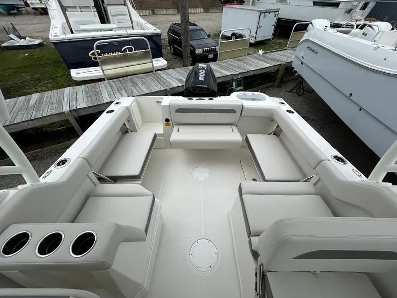 Slide: The Image of 2025 Sailfish 245 DC boat interior with spacious seating and cup holders. - 18