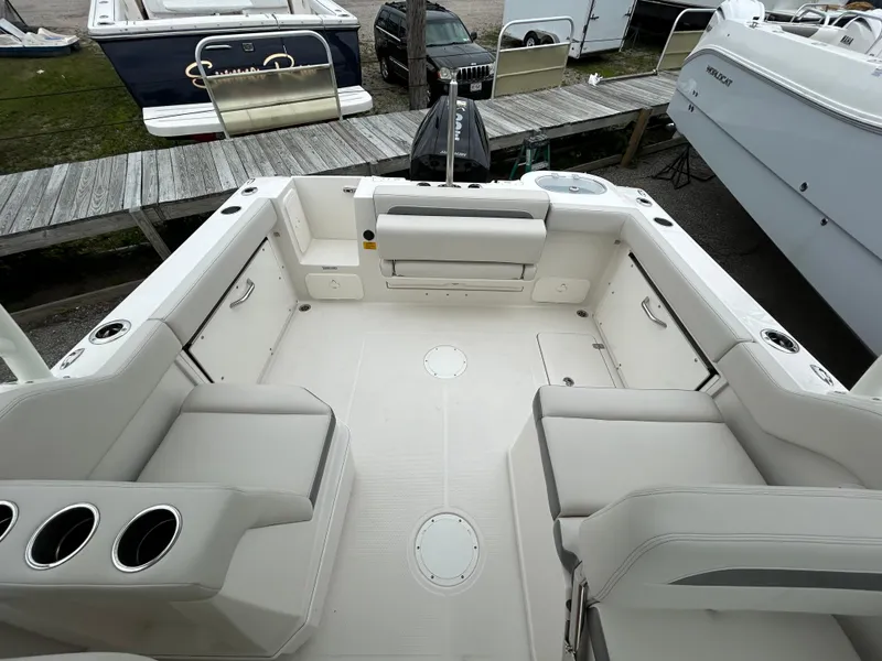 Slide: The Image of 2025 Sailfish 245 DC boat interior with spacious seating and cup holders. - 19