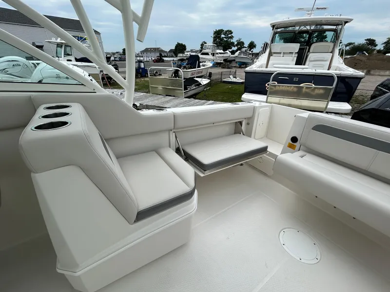 Slide: The Image of 2025 Sailfish 245 DC boat interior with seating and cup holders. - 20