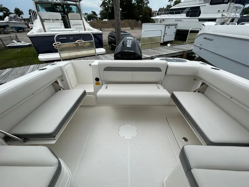Slide: The Image of 2025 Sailfish 245 DC boat interior with white seating and spacious layout. - 21