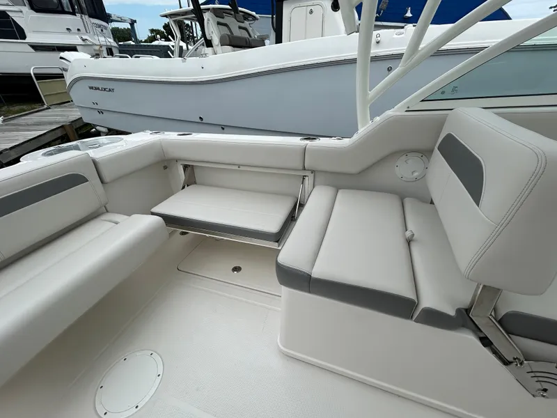 Slide: The Image of 2025 Sailfish 245 DC boat interior with white and gray seating. - 22