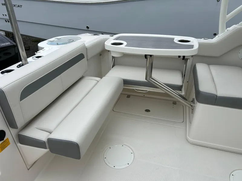 Slide: The Image of 2025 Sailfish 245 DC boat interior with seating and table. - 24