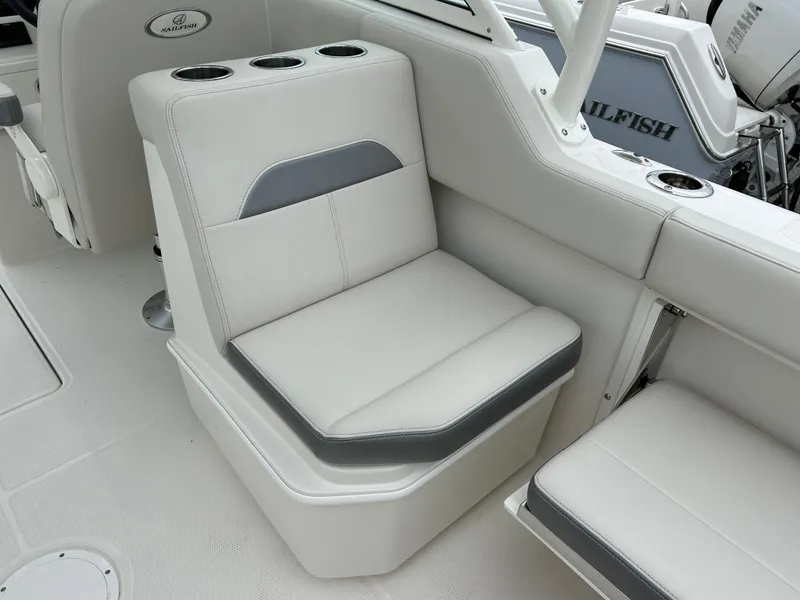 Slide: The Image of 2025 Sailfish 245 DC boat interior seating with cup holders. - 25