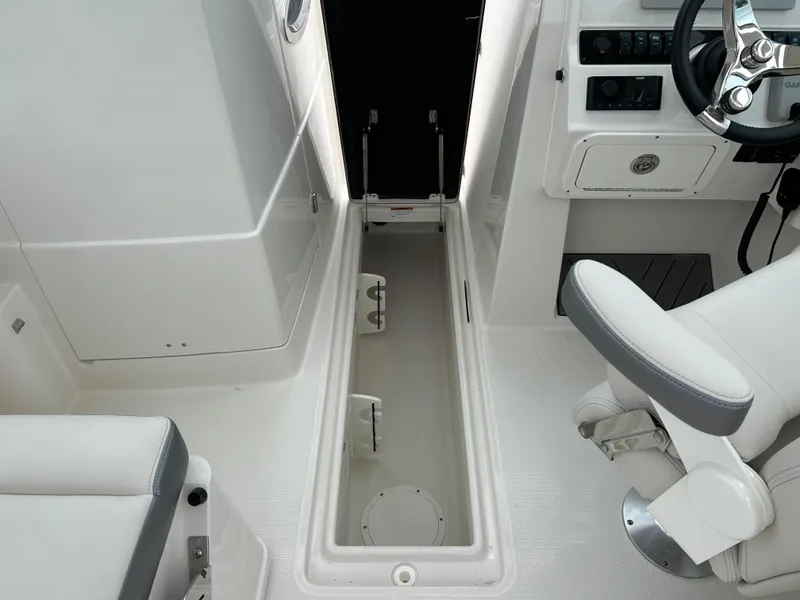 Slide: The Image of Interior view of 2025 Sailfish 245 DC boat showing storage compartment. - 27