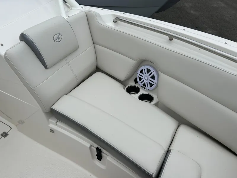 Slide: The Image of 2025 Sailfish 245 DC boat interior with cushioned seating and built-in cup holders. - 4