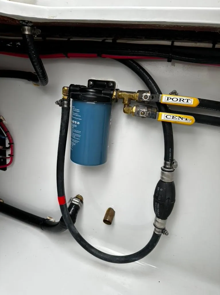 Slide: The Image of 2019 Contender 32 ST boat engine compartment with fuel filter and hoses. - 11