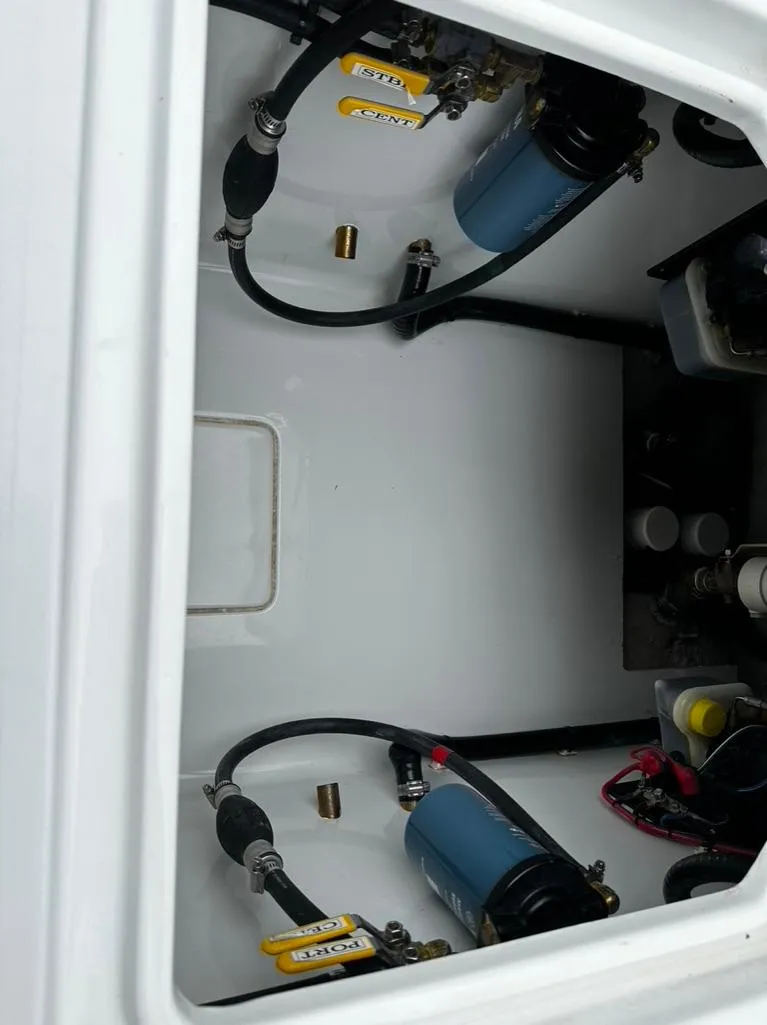 Slide: The Image of 2019 Contender 32 ST boat engine compartment with fuel filters and hoses. - 9