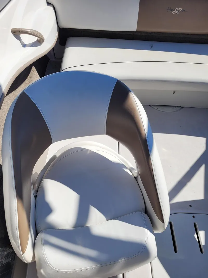 Slide: The Image of 2007 Four Winns 190 Horizon boat interior with white and tan seating. - 11