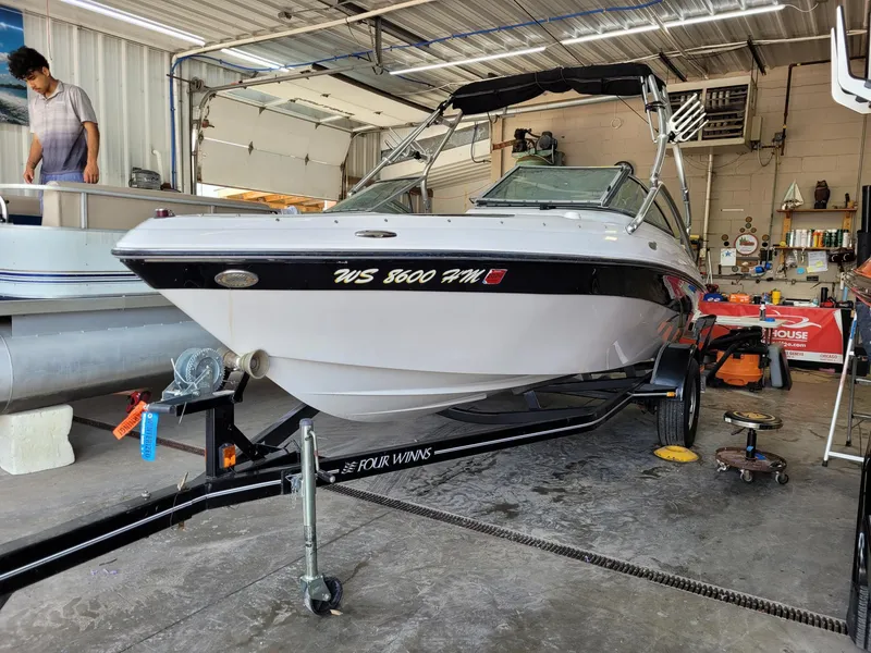 Slide: The Image of 2007 Four Winns 190 Horizon boat in a garage, on a trailer. - 20