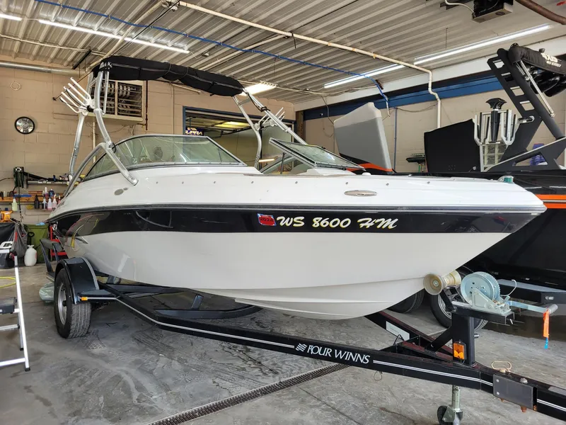 Slide: The Image of 2007 Four Winns 190 Horizon boat on trailer in garage setting. - 21