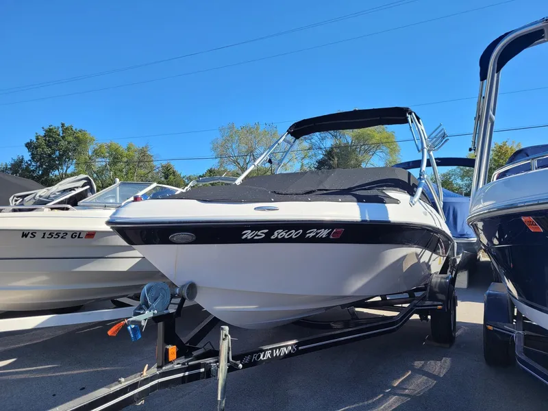 Slide: The Image of 2007 Four Winns 190 Horizon boat on trailer, parked outdoors under clear blue sky. - 3