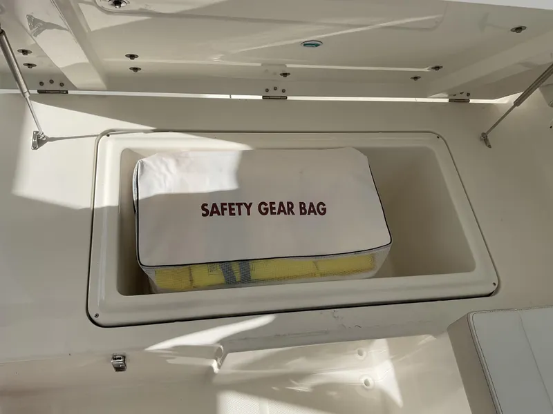 Slide: The Image of Safety gear bag in storage compartment of 2025 World Cat 400 DC-IS boat. - 13