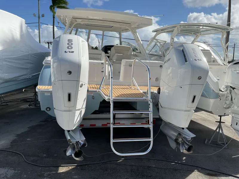 Slide: The Image of 2025 World Cat 400 DC-IS boat with twin outboard engines, docked under a sunny sky. - 22