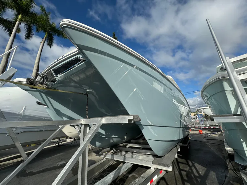 Slide: The Image of 2025 World Cat 400 DC-IS boat on trailer under clear sky. - 8