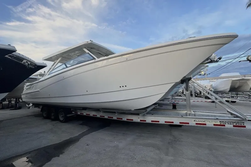The Image of 2026 World Cat 400 DC-X Island boat on trailer under blue sky. - 0