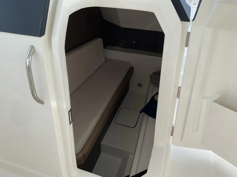 Slide: The Image of Interior cabin of 2025 World Cat 400 DC-IS boat, featuring a cozy seating area. - 6
