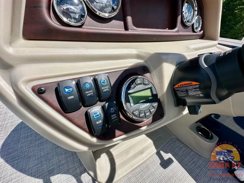 Slide: The Image of Control panel of 2025 South Bay 220CR LE pontoon boat with gauges and switches. - 16