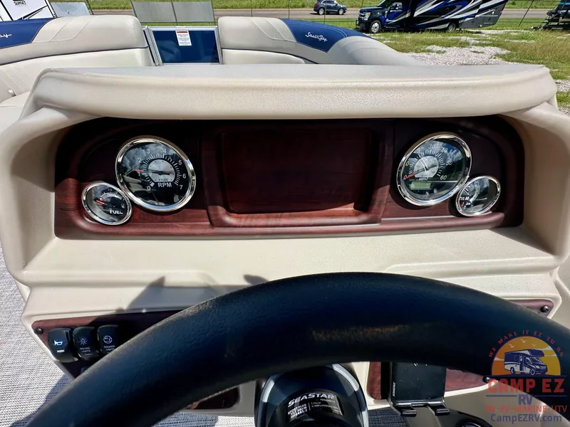 Slide: The Image of Dashboard of 2025 South Bay 220CR LE pontoon boat with gauges and steering wheel. - 17
