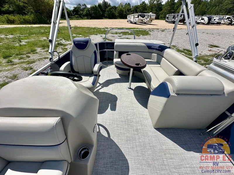 Slide: The Image of 2025 South Bay 220CR LE pontoon boat interior with plush seating and table. - 20