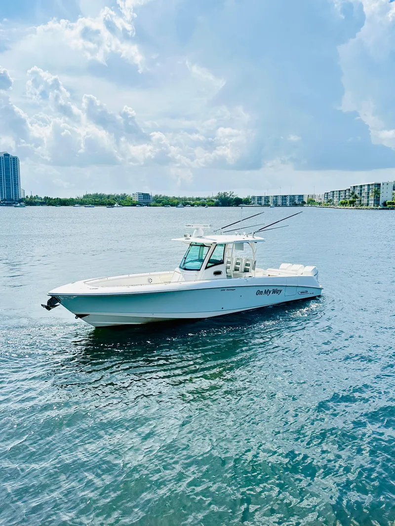 The Image of 2016 Boston Whaler 350 Outrage boat on calm water under a cloudy sky. - 0