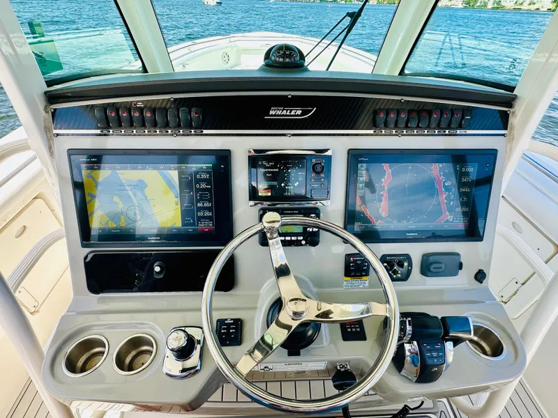 Slide: The Image of 2016 Boston Whaler 350 Outrage helm with dual navigation screens and steering wheel. - 12