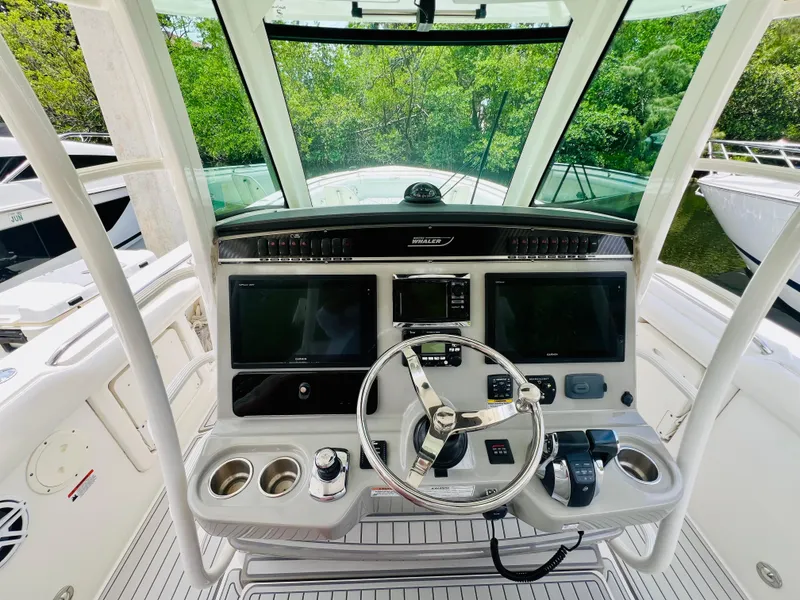 Slide: The Image of Boston Whaler 350 Outrage 2016 helm with dual screens and steering wheel. - 13