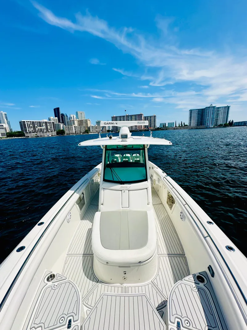 Slide: The Image of 2016 Boston Whaler 350 Outrage boat on water with city skyline background. - 14