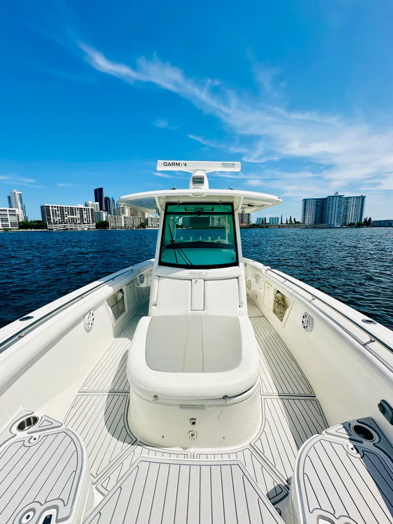 Slide: The Image of 2016 Boston Whaler 350 Outrage boat on water with city skyline background. - 15