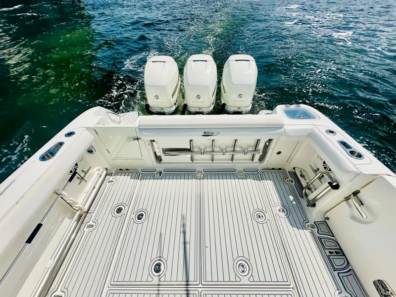 Slide: The Image of 2016 Boston Whaler 350 Outrage boat with triple engines on open water. - 18