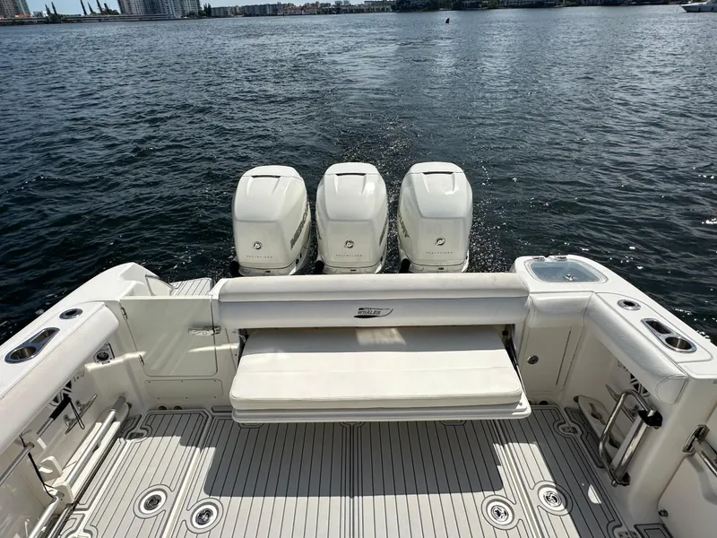 Slide: The Image of 2016 Boston Whaler 350 Outrage boat with triple outboard engines on open water. - 19
