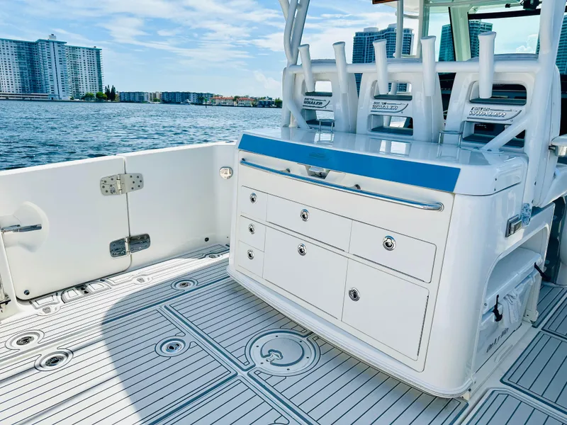 Slide: The Image of 2016 Boston Whaler 350 Outrage boat interior with storage drawers, ocean view, and city skyline. - 20