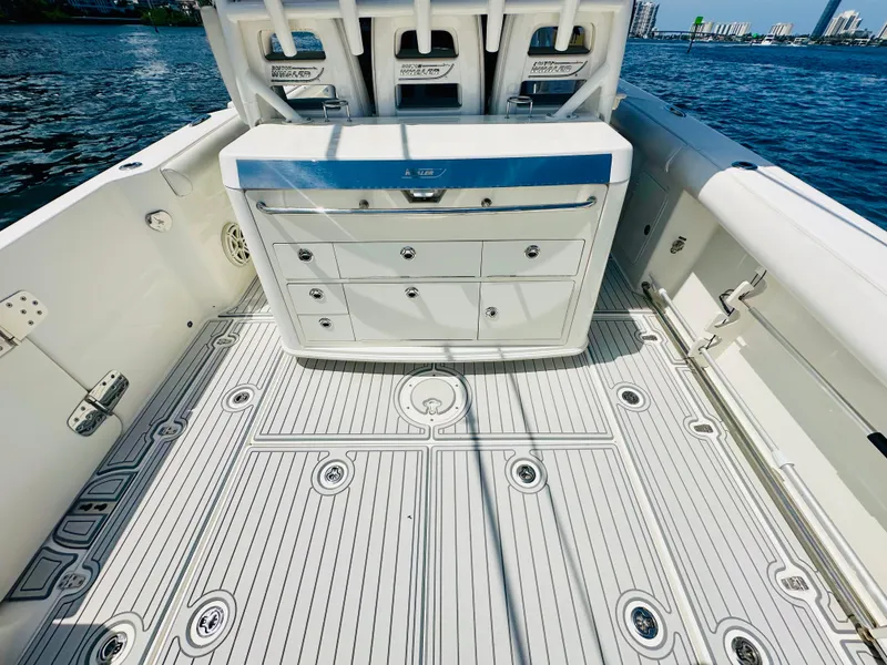 Slide: The Image of 2016 Boston Whaler 350 Outrage boat interior with storage drawers and sleek deck design. - 21