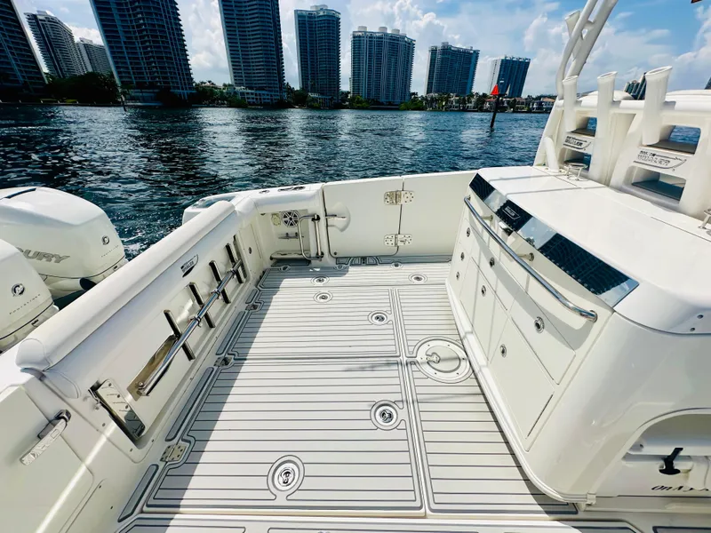 Slide: The Image of 2016 Boston Whaler 350 Outrage boat deck with city skyline in background. - 23