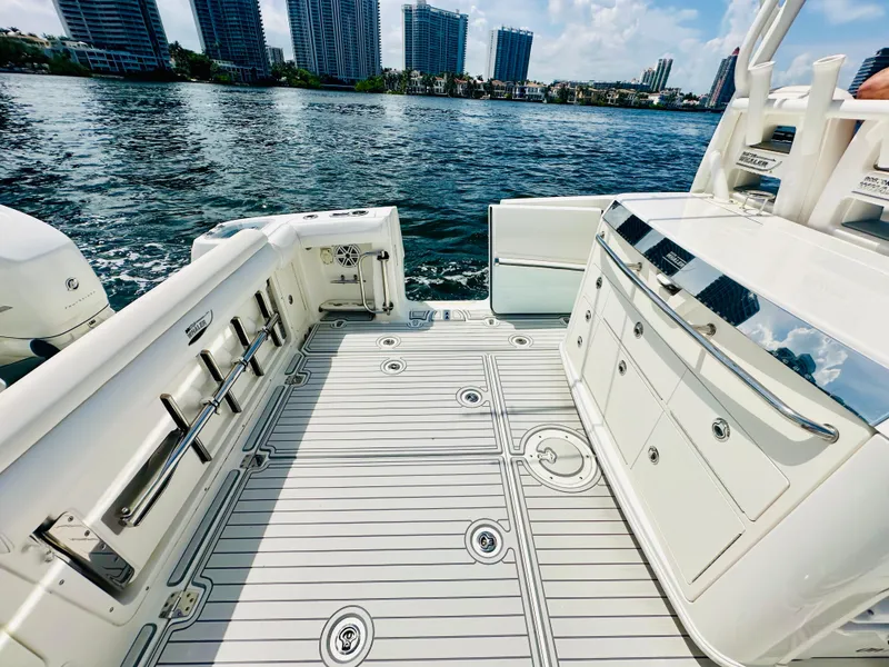 Slide: The Image of 2016 Boston Whaler 350 Outrage boat deck with city skyline in background. - 24