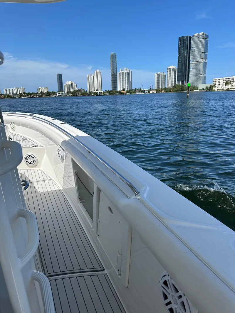 Slide: The Image of Boston Whaler 350 Outrage 2016 cruising near city skyline on a sunny day. - 32