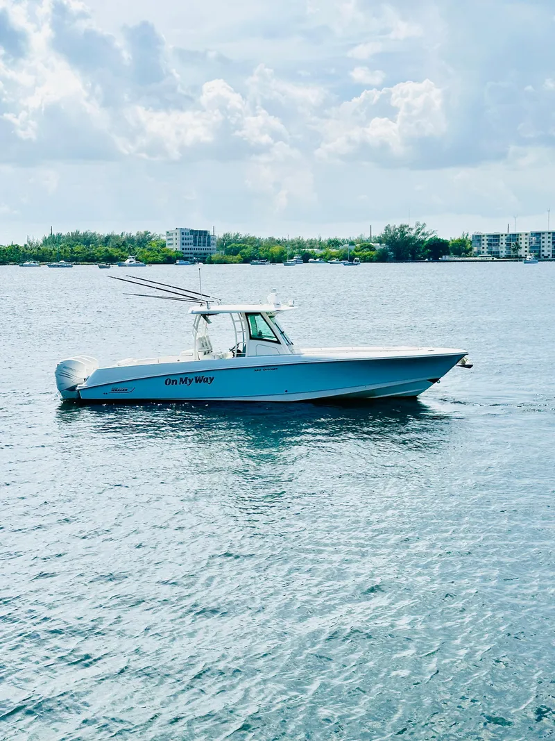 Slide: The Image of 2016 Boston Whaler 350 Outrage boat cruising on a calm, scenic waterway. - 4