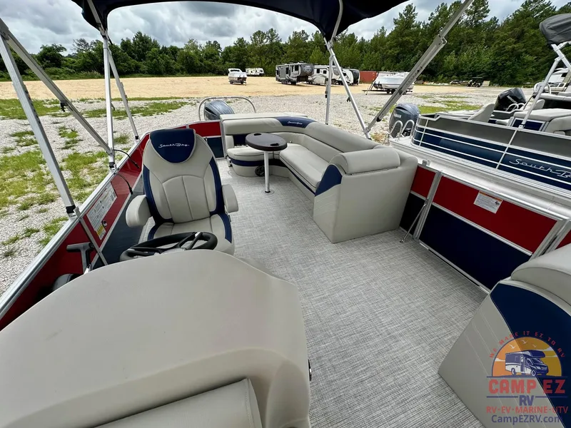 Slide: The Image of 2025 South Bay 224CR LE pontoon boat interior with seating and table. - 11