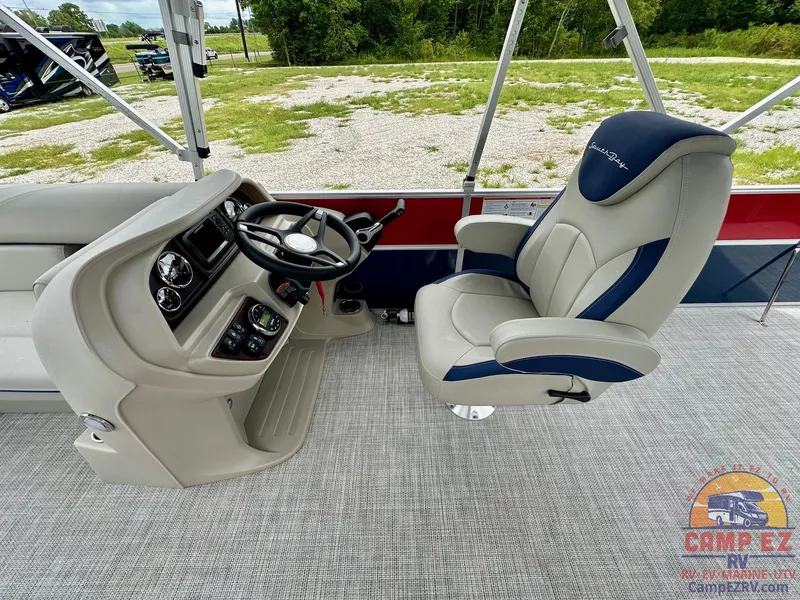 Slide: The Image of 2025 South Bay 224CR LE boat interior with captain's chair and steering console. - 12