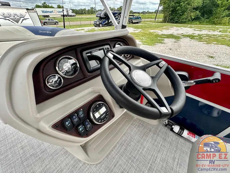Slide: The Image of 2025 South Bay 224CR LE boat dashboard with steering wheel and control panel. - 13
