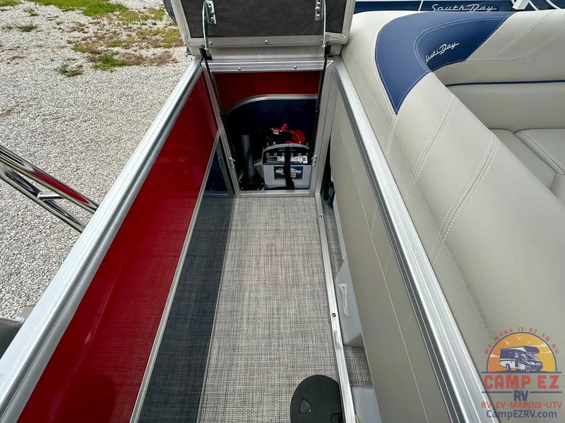 Slide: The Image of 2025 South Bay 224CR LE boat storage compartment with battery and seating. - 19