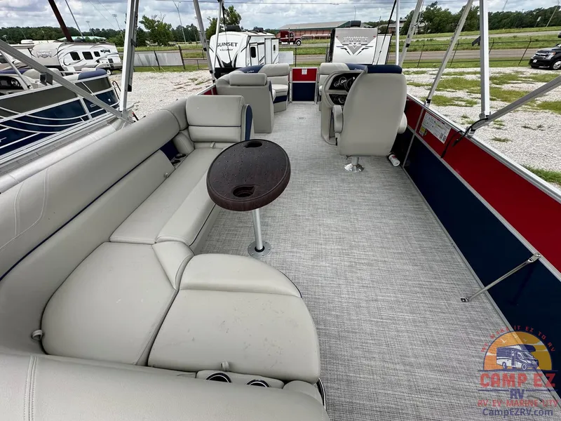 Slide: The Image of 2025 South Bay 224CR LE pontoon boat interior with spacious seating and table. - 20