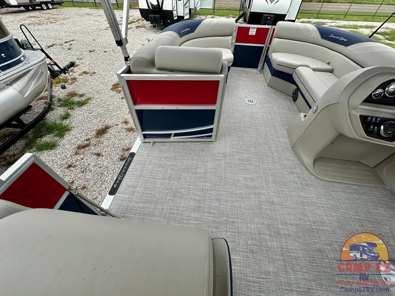 Slide: The Image of 2025 South Bay 224CR LE pontoon boat interior with gray seating and red-blue accents. - 21