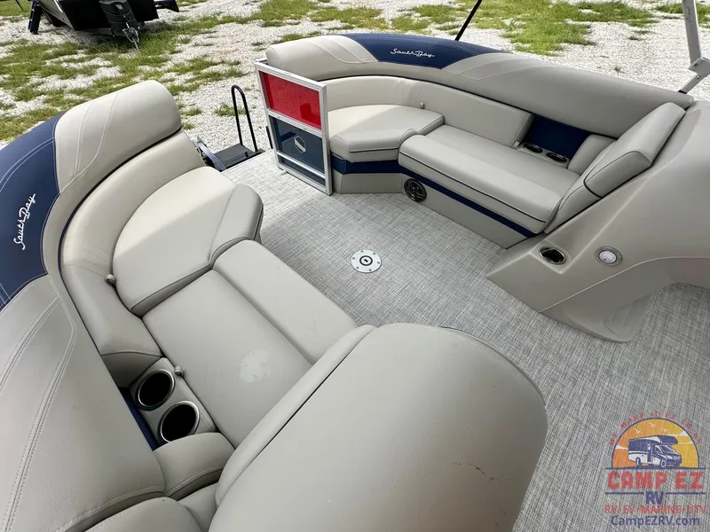 Slide: The Image of 2025 South Bay 224CR LE pontoon boat interior with plush seating and cup holders. - 22