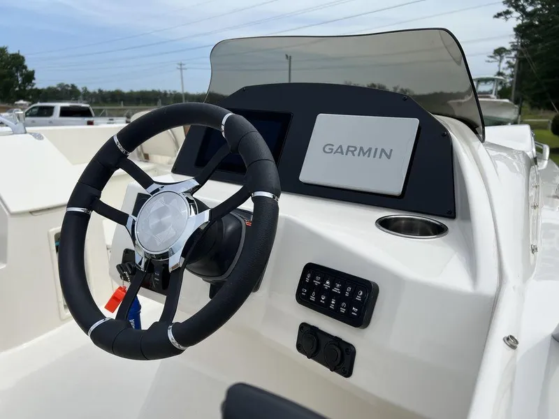Slide: The Image of 2024 Stingray 212SC boat dashboard with Garmin navigation system and steering wheel. - 4