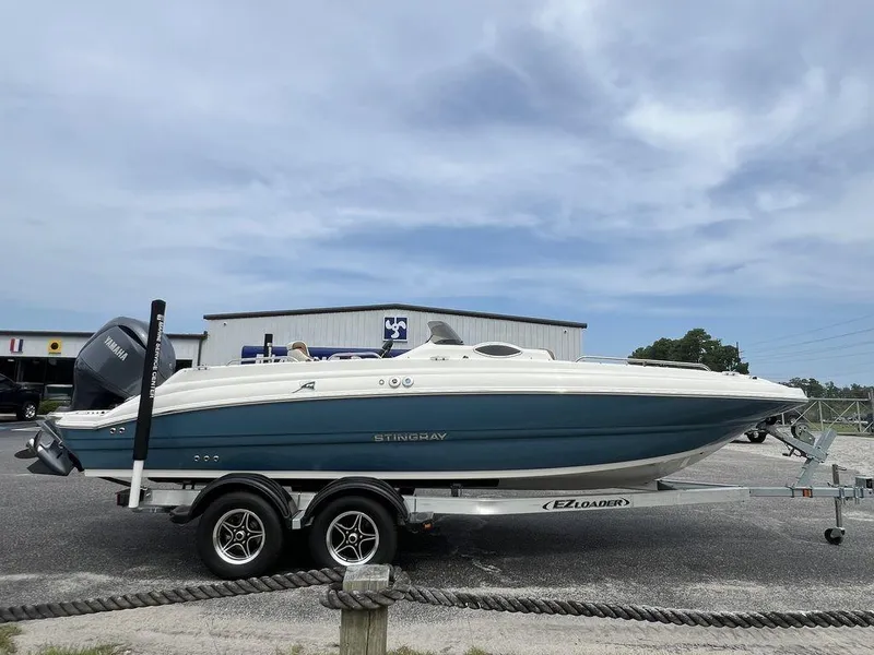 Slide: The Image of 2024 Stingray 212SC boat on a trailer in a parking lot. - 7