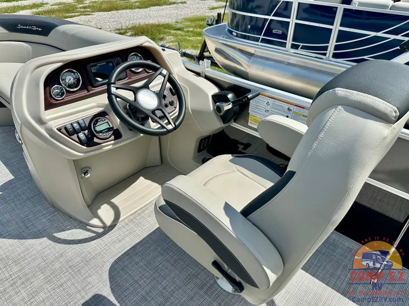 Slide: The Image of 2025 South Bay 220CR LE boat cockpit with steering wheel and captain's chair. - 17