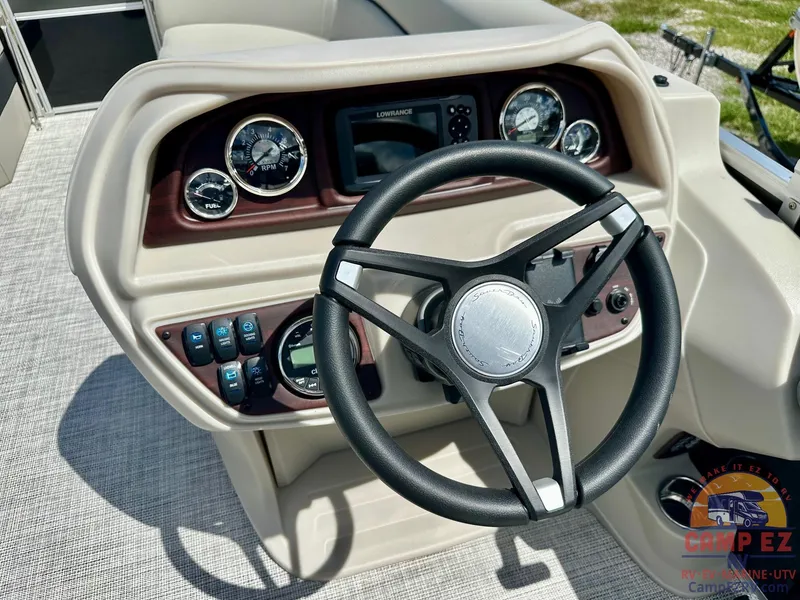 Slide: The Image of Steering console of 2025 South Bay 220CR LE pontoon boat with gauges and controls. - 18
