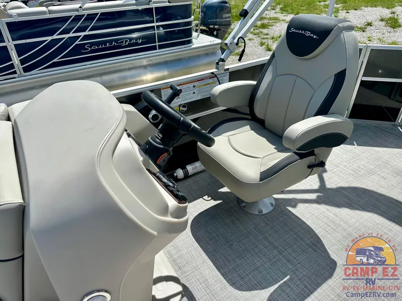 Slide: The Image of 2025 South Bay 220CR LE boat interior with captain's chair and steering console. - 22