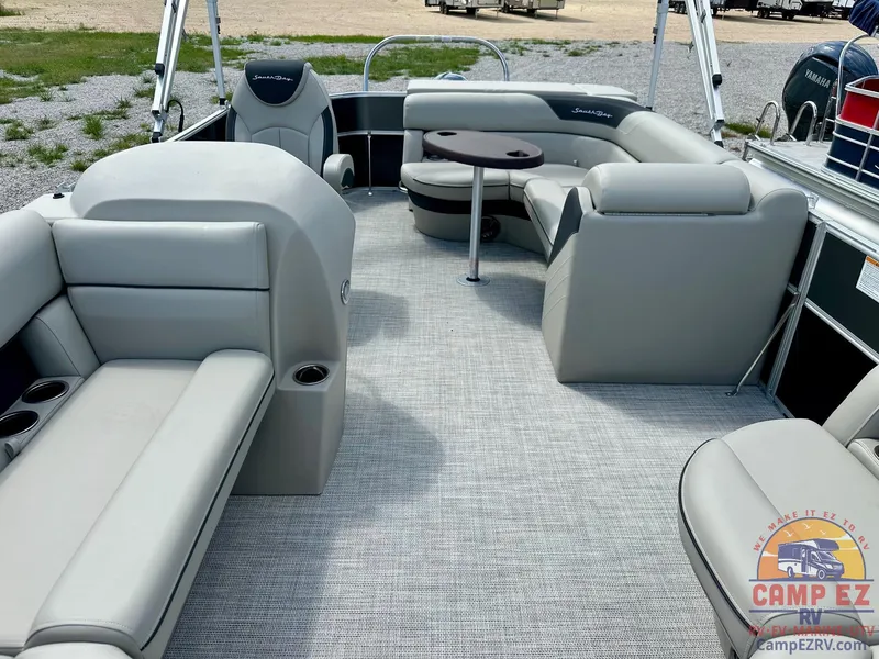 Slide: The Image of 2025 South Bay 220CR LE pontoon boat interior with gray seating and table. - 25